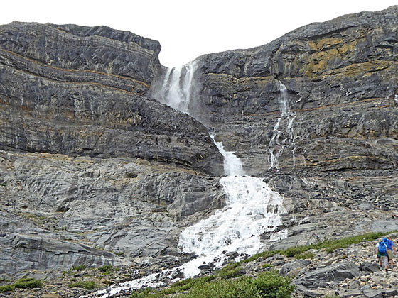 Water pouring through a break in the cliff face 