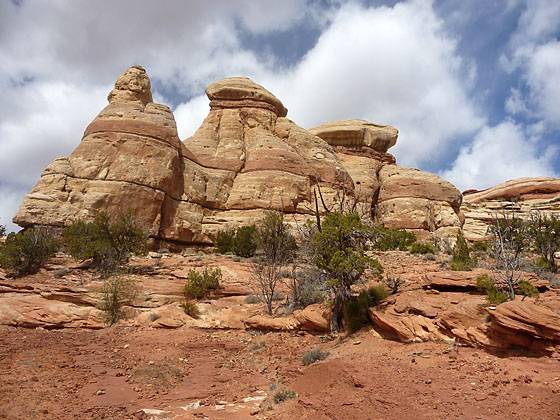 Colorful rock formations rising above the west side of the trail.